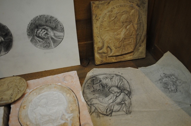 De detrs a delante y de izquierda a derecha:  Proyecto  de medalla (no realizada) para la Asociacin de Crticos de Arte.  Modelo para hacer reduccin pantogrfica Modelo en polister de la Medalla de la Complutense Primeros estudios para la Medalla de l